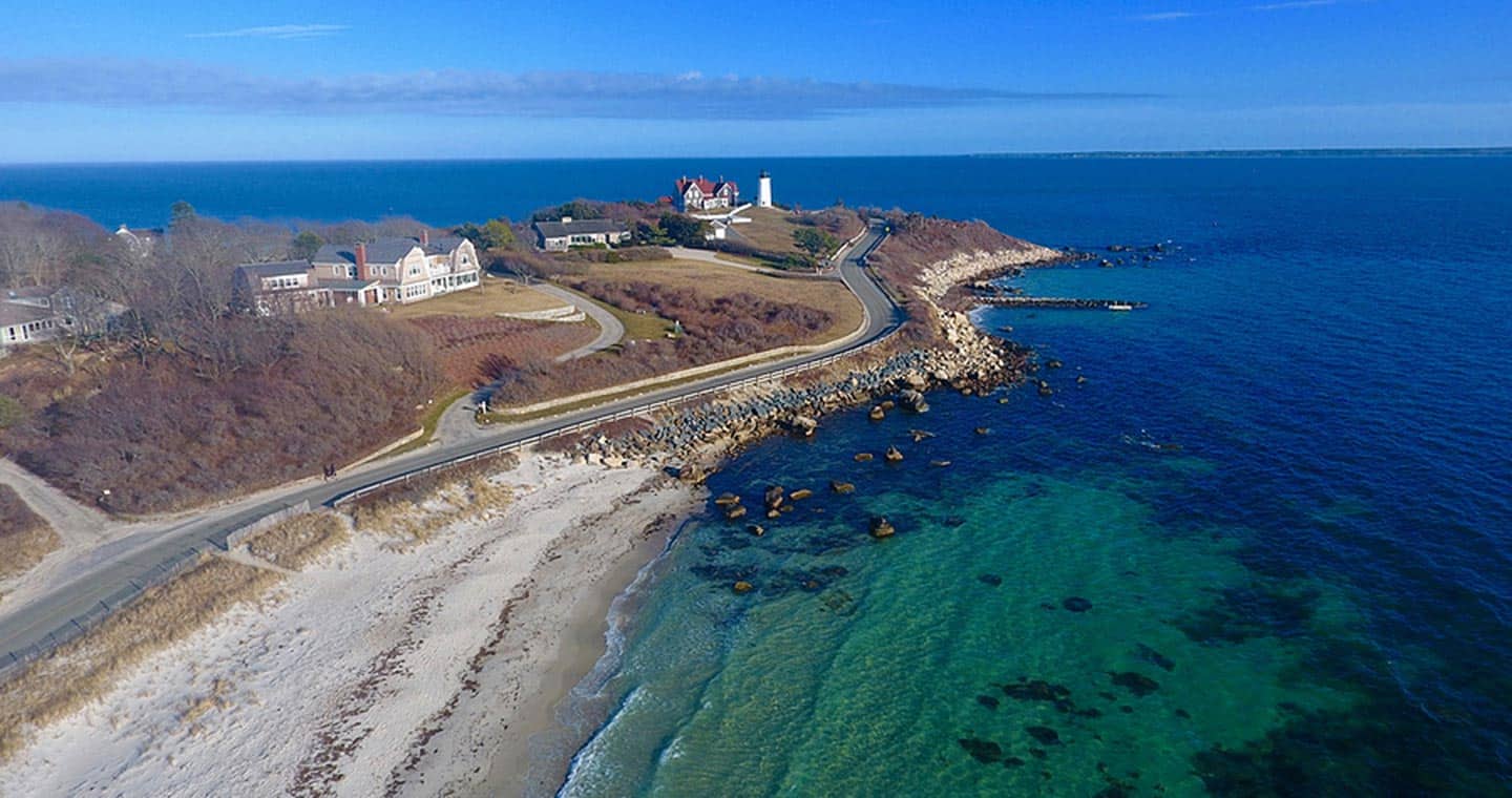 Lighthouse, Ocean and beach road aerial view of Cape Cod.