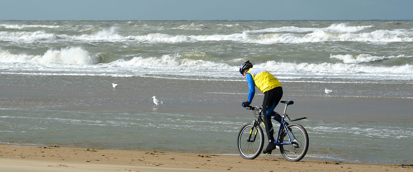 Man biking on the beach