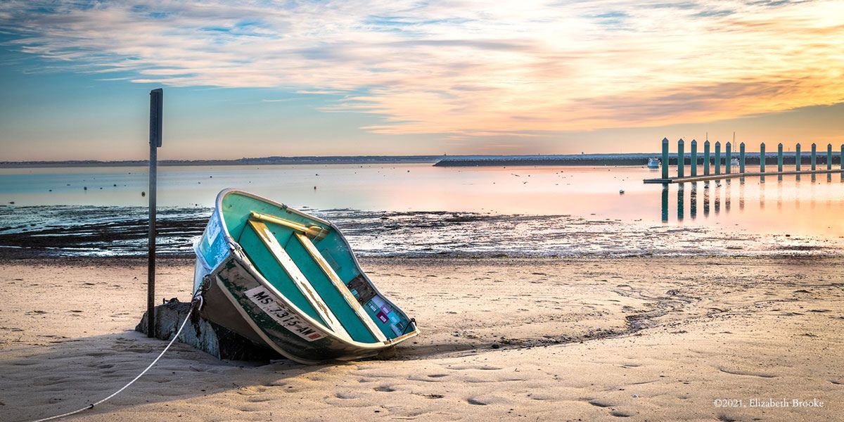 Visit Provincetown: a boat on the shore of the beach town