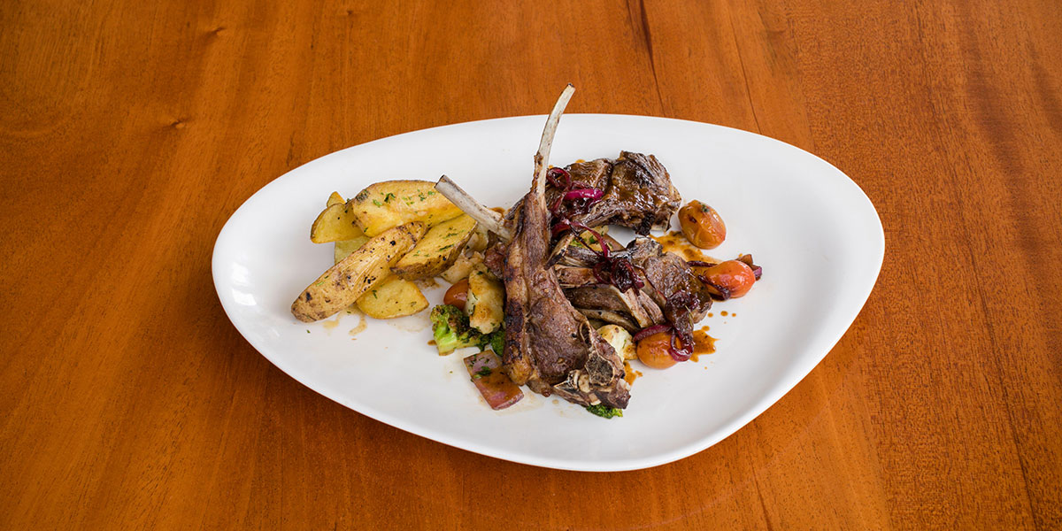 A rack of lamb with side dish - one of the things you can order at The Mews, a Provincetown restaurant