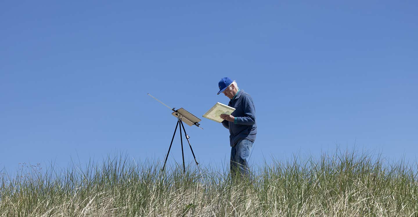 Provincetown long weekend man painting in the dunes