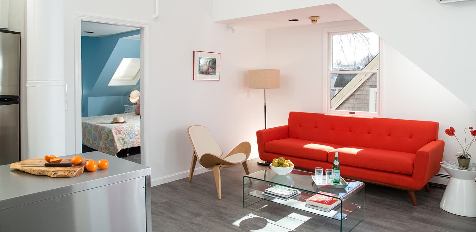 Red couch in living room of Spacious Julia Child Suite