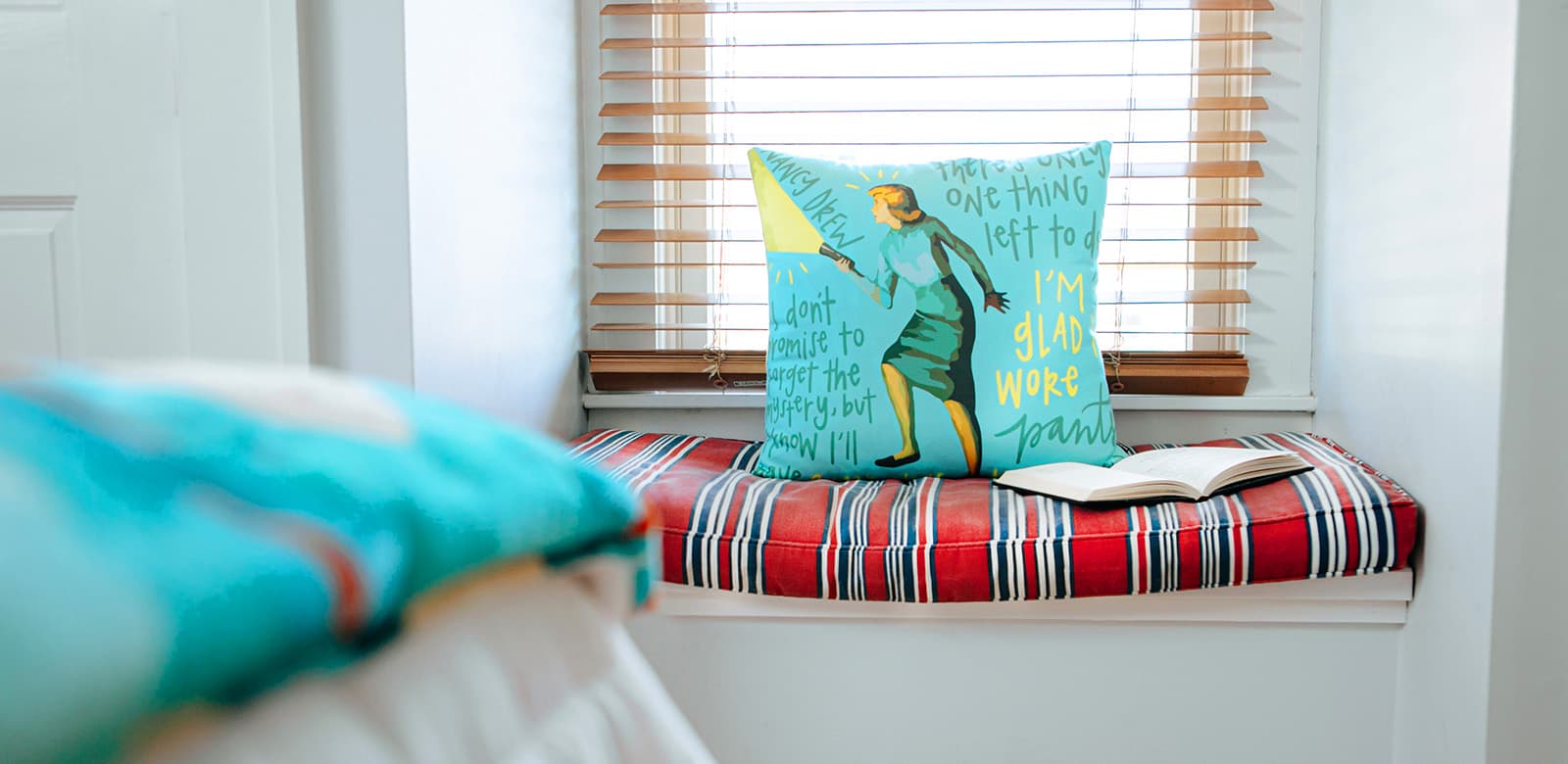 Reading corner with throw pillow at Agatha Christie