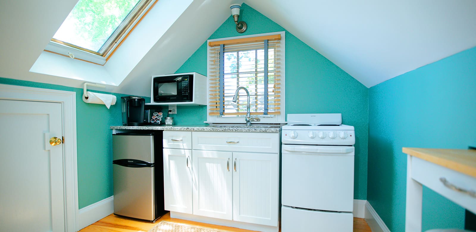 Ariel fully-equipped kitchen with burners, oven, coffee maker, refrigerator, and microwave