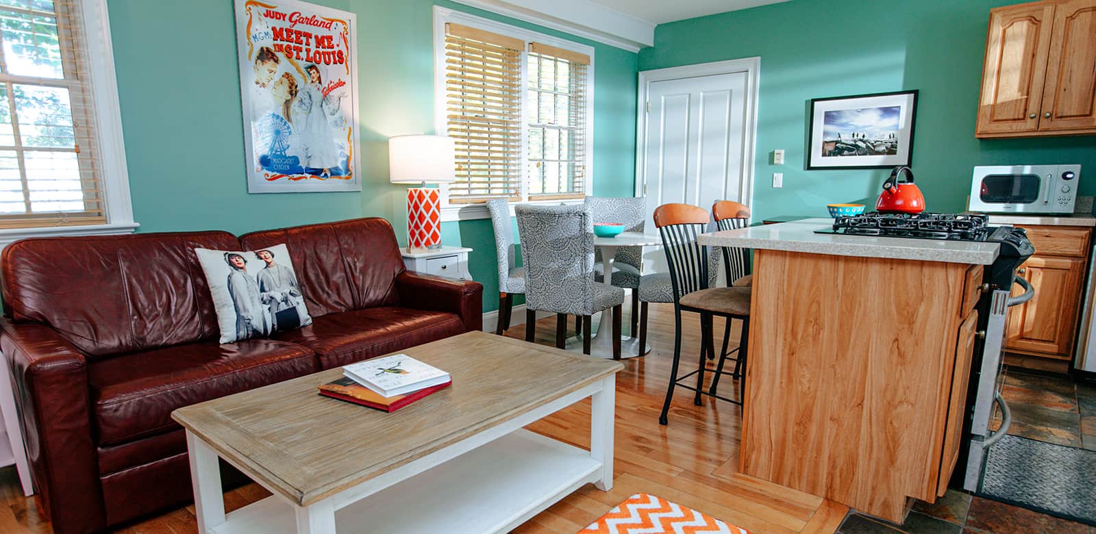 Sitting area at Bella with view of the fully-equipped kitchen and dining area