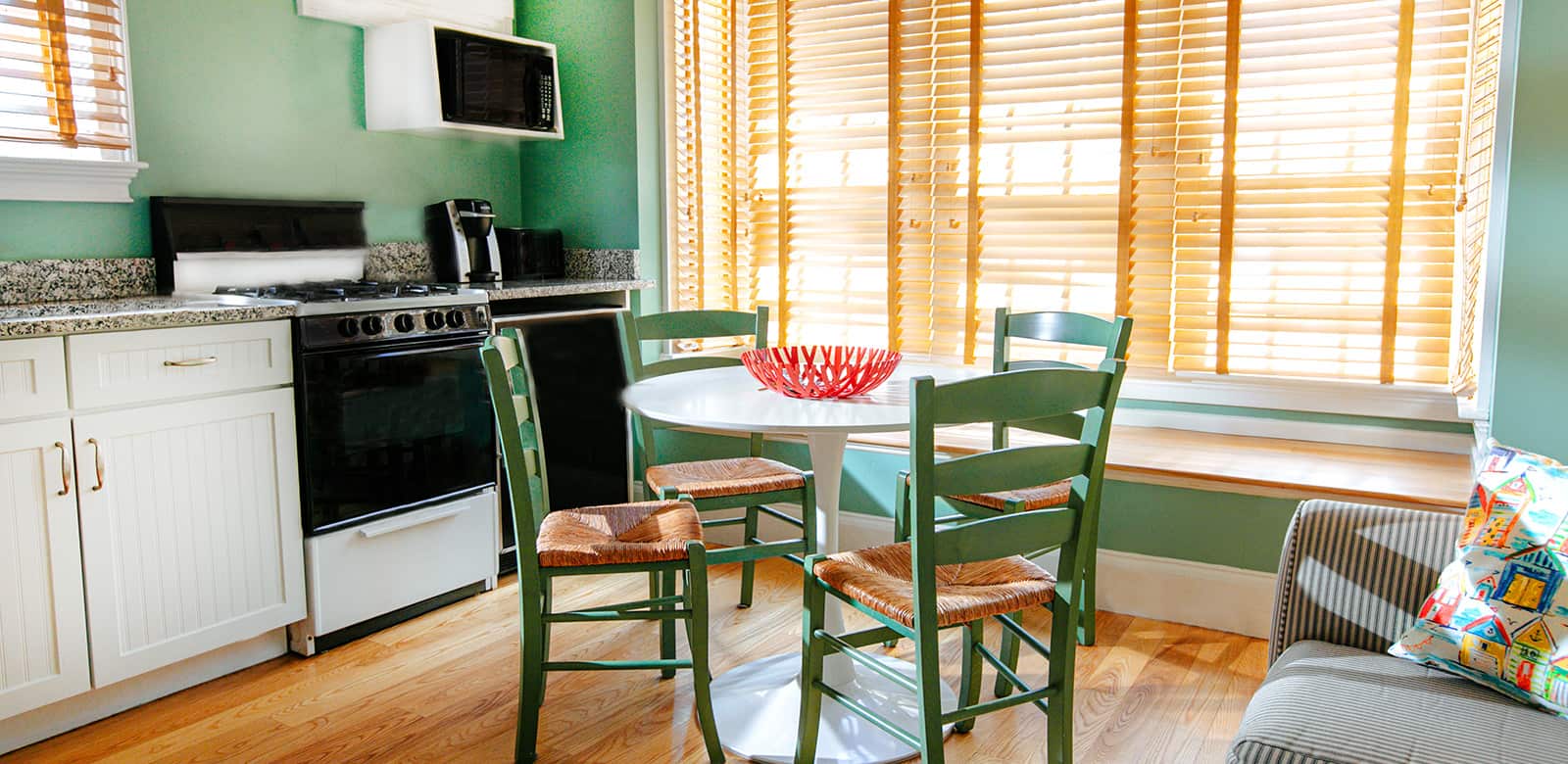Fully-equipped kitchen with dining area and a large window at Laurel