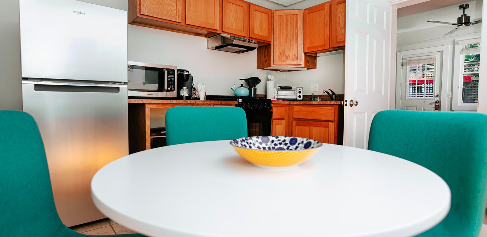 Fully equipped kitchen and dining area with table and chairs at Michael room