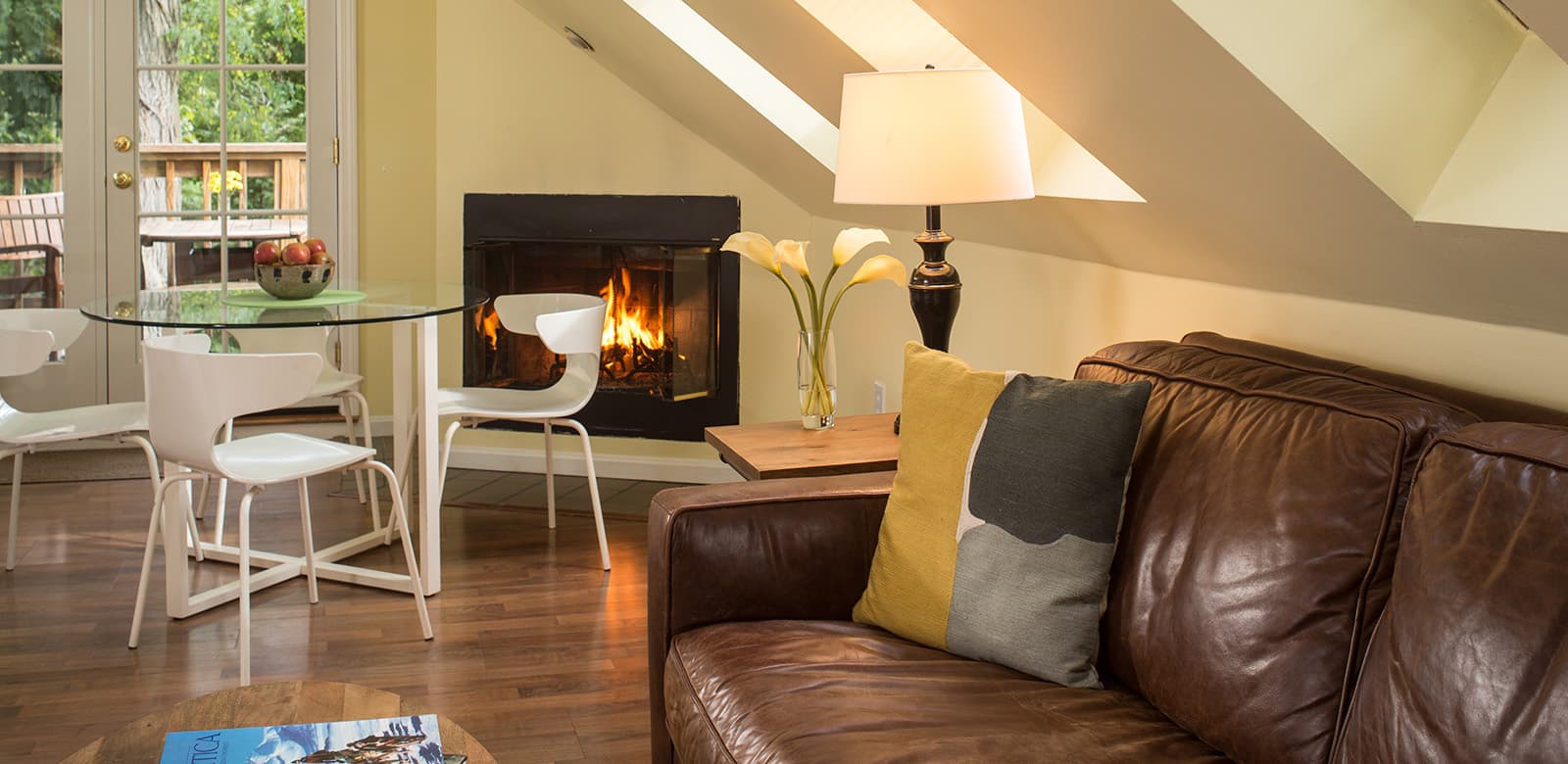 Gas fireplace, leather sofa and dining table
