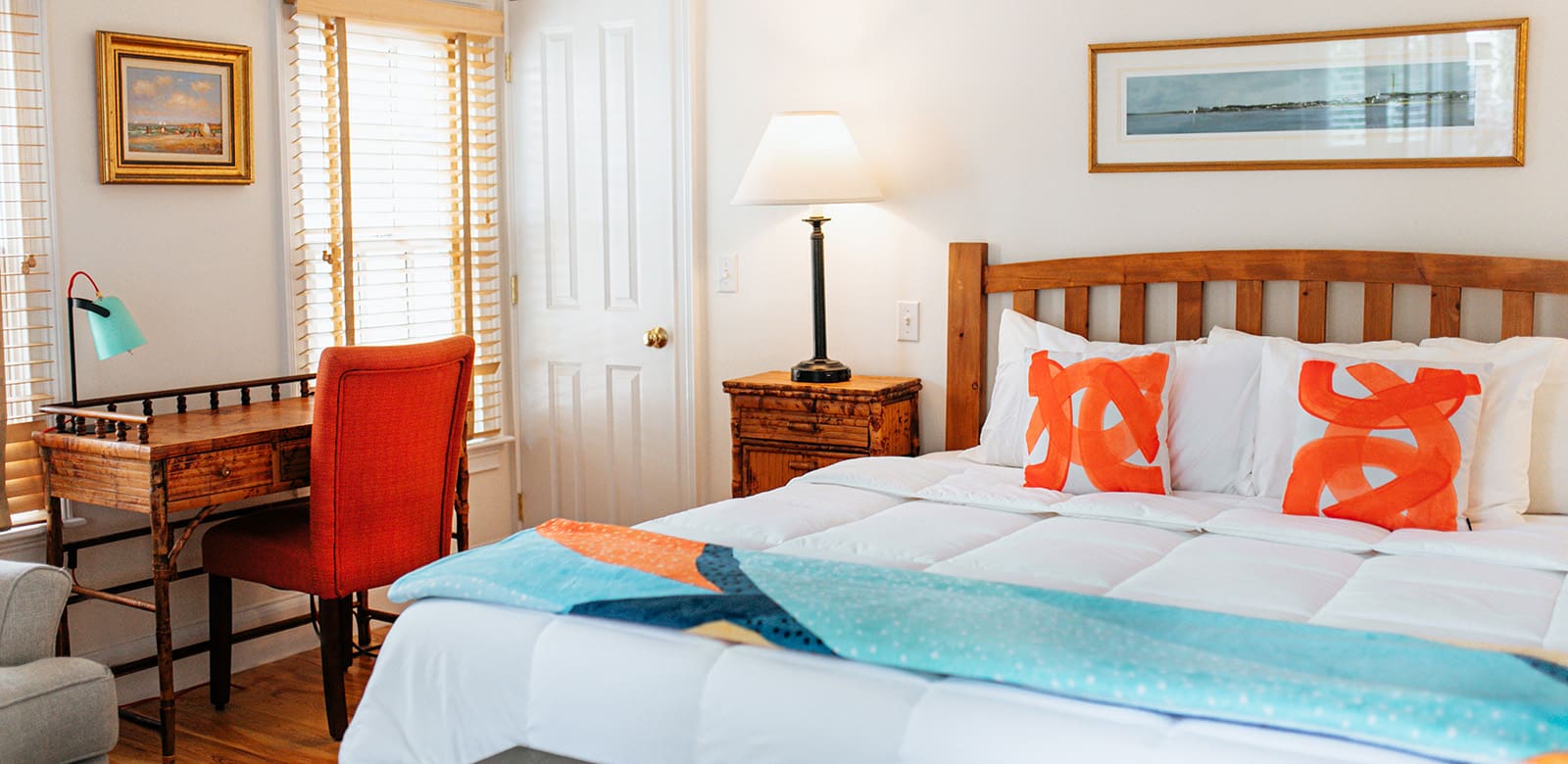 King size bed and working area with a chair and table at Olivia