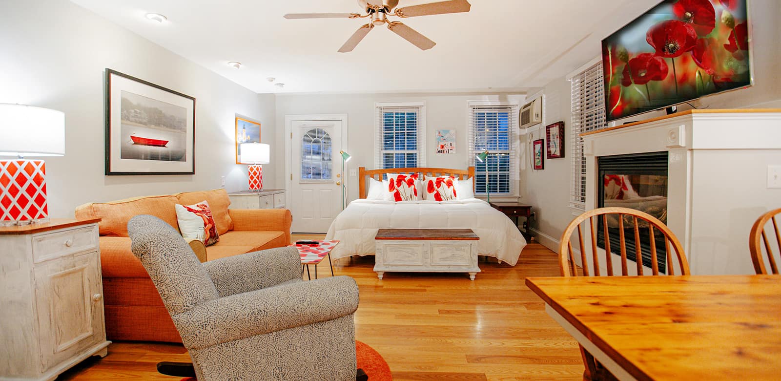 Susan room with large bed, sitting area, dining table, and fireplace