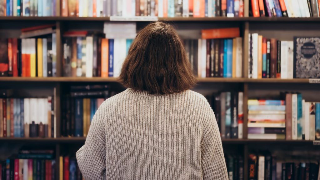 A woman looking at books at a Provincetown shop